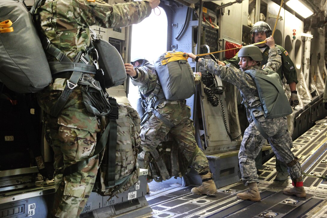 A jumpmaster inspects the door on an Air Force C-17 Globemaster aircraft before participating in a mass tactical airborne jump during Operation Anvil refresher training at North Air Force Auxiliary Base, S.C., Jan. 26, 2017. Army photo by Spc. Christopher Martin