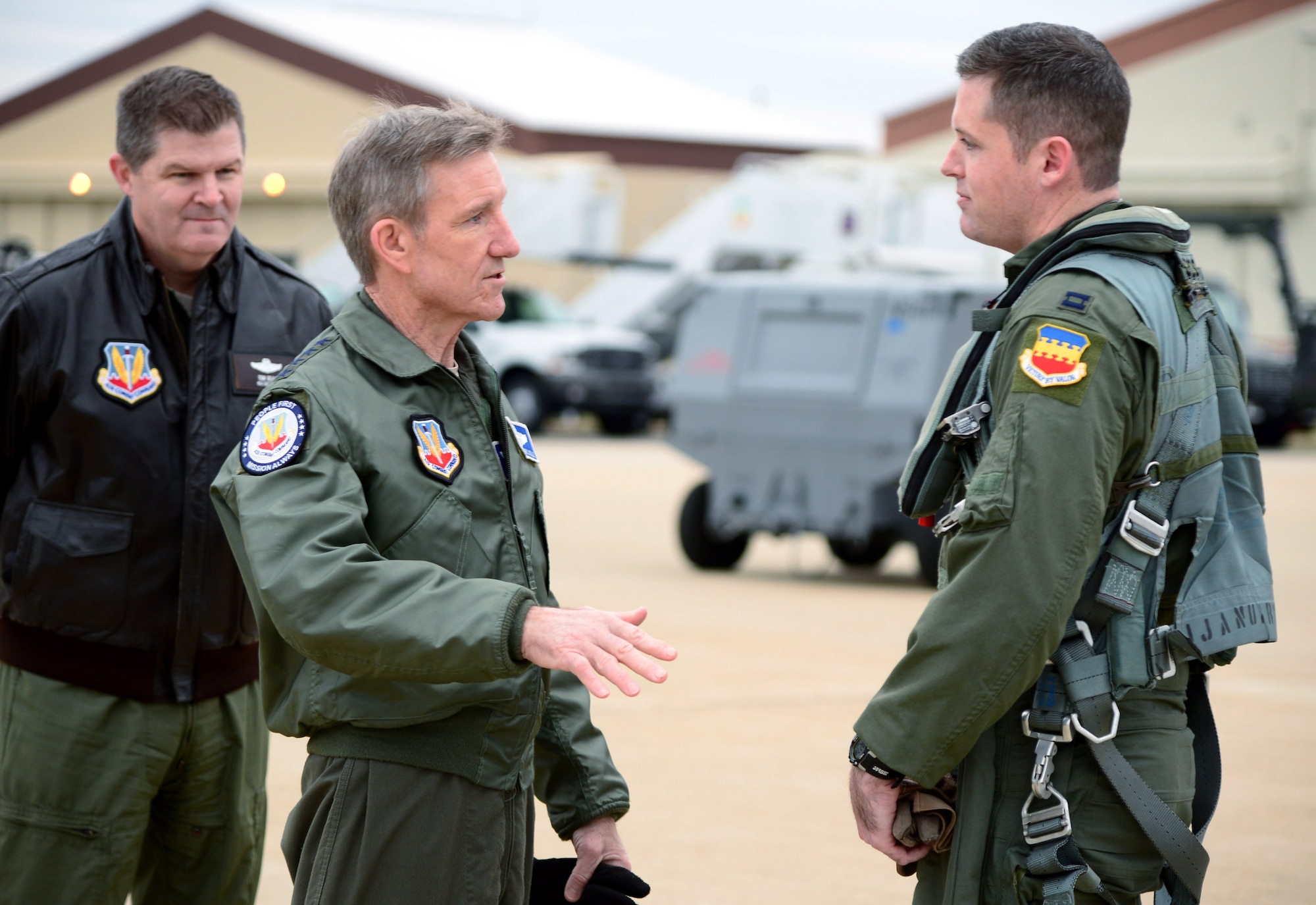 Gen. Hawk Carlisle (center), commander of Air Combat Command, and Maj. Gen. Thomas Deale, ACC A3, congratulate Capt. John "Rain" Waters, on certifying as the pilot for the 2017-18 F-16 Viper demonstration team Feb. 1, 2017 at Langley Air Force Base, Va. Demonstration pilots, who perform at air shows worldwide, serve two-year tours on their respective teams, and must be certified at multiple levels. Carlisle, as COMACC, was Waters' final level of certification, and named him as a demo pilot immediatley after the flight. (U.S. Air Force photo by Emerald Ralston)