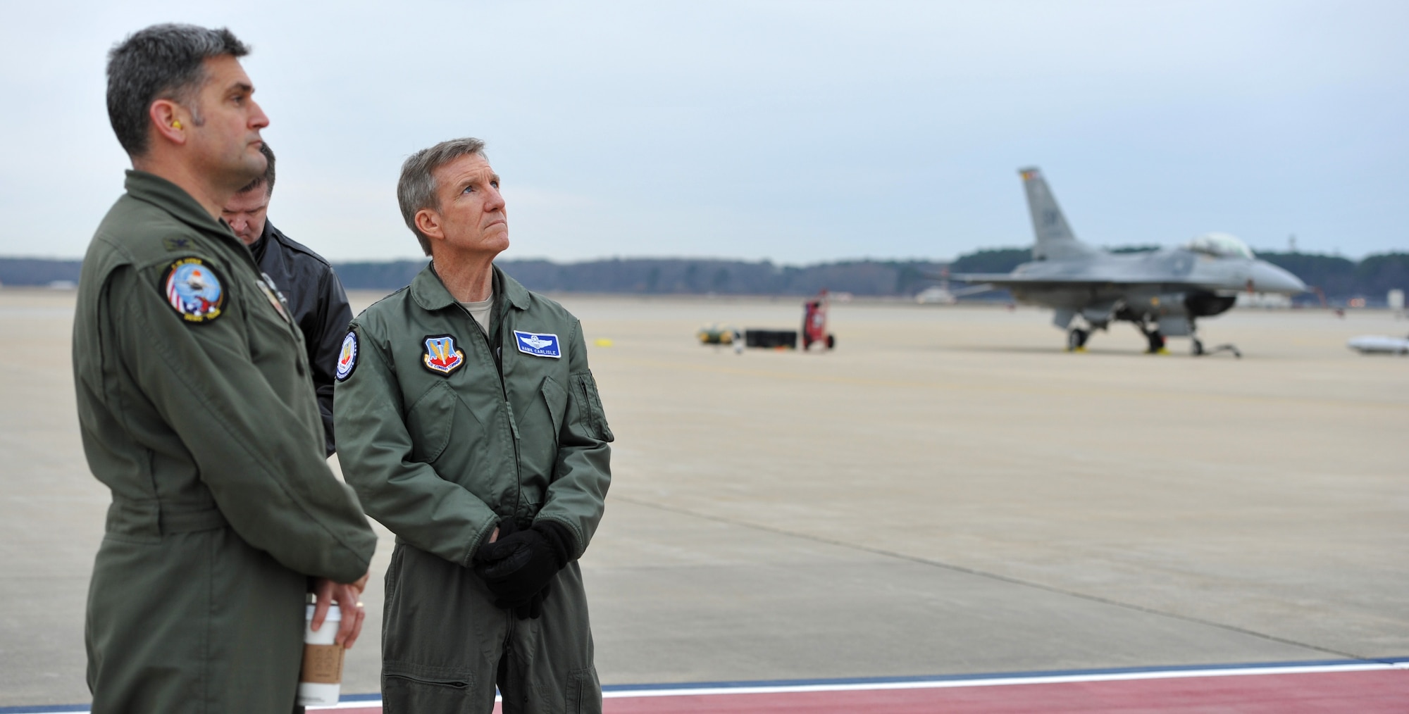 Gen. Hawk Carlisle (right), commander of Air Combat Command, watches alongside Col. Douglas Thies, 20th Operations Group commander and Maj. Gen. Thomas Deale, ACC A3, as Capt. John "Rain" Waters flies his F-16 Fighting Falcon in a demonstration in hopes of qualifying as a pilot for the 2017-18 F-16 demonstration team Feb. 1, 2017 at Langley Air Force Base, Va. Demonstration pilots, who perform at air shows worldwide, serve two-year tours on their respective teams, and must be certified at multiple levels. Carlisle, as COMACC, was Waters' final level of certification, and named him as a demo pilot immediatley after the flight. (U.S. Air Force photo by Emerald Ralston)