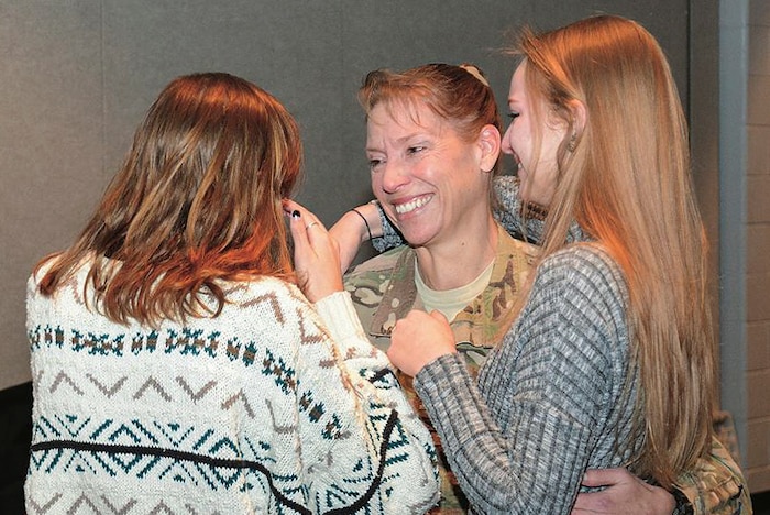 Col. Beth Prekker surprises her daughters, Lindsay and Caroline at Cosby High School, Midlothian, Va., Jan. 5, 2017, after being deployed in Iraq for one year. Army photo by Lesley Atkinson