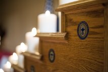 A chief coin rests in a ceremonial candle display at the Chief Induction Ceremony, Jan. 28, 2017, at Moody Air Force Base, Ga. The candles signify the climb up the rank structure. The induction ceremony is a time-honored tradition that recognizes Airmen as they make the transition from senior master sergeant to chief master sergeant. (U.S. Air Force photo by Andrea Jenkins/Released)