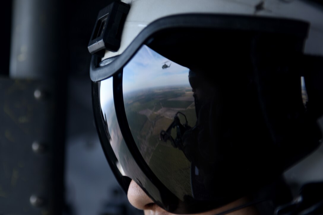 U.S. Marine Corps First Lt. Richard Leung, a UH-1Y crew member with the Marine Light Aircraft Helicopter Squadron 269 from Marine Corps Air Station New River, in Jacksonville, North Carolina, watches an AH-1W Super Cobra fly alongside him during a tactical recovery of aircraft and personnel exercise, Jan. 31, 2017, in Kinston, North Carolina. During the exercise, the crew was able to suppress enemy forces and extract the downed aircrew from hostile territory. (U.S. Air Force photo by Senior Airman Brittain Crolley)