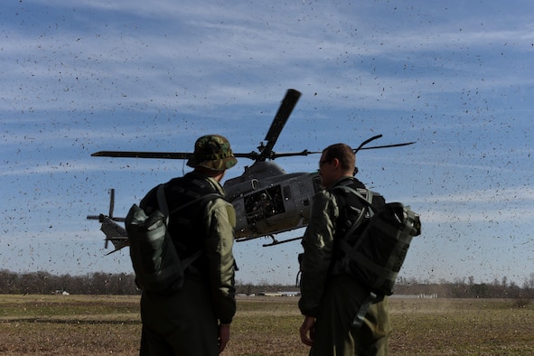 Air Force Capt. Cody Williams, a 336th Fighter Squadron pilot and weapons systems officer, and Capt. Steve Keck, a 336th FS pilot, are located by a rescue team in an AH-1W Super Cobra assigned to the Marine Light Aircraft Helicopter Squadron 269 from Marine Corps Air Station New River, Jacksonville, N.C., during a tactical recovery of aircraft and personnel exercise, Jan. 31, 2017, in Kinston, N.C. Williams and Keck successfully evaded simulated enemy forces and coordinated rescue during the scenario. (U.S. Air Force photo/Airman Miranda A. Loera)