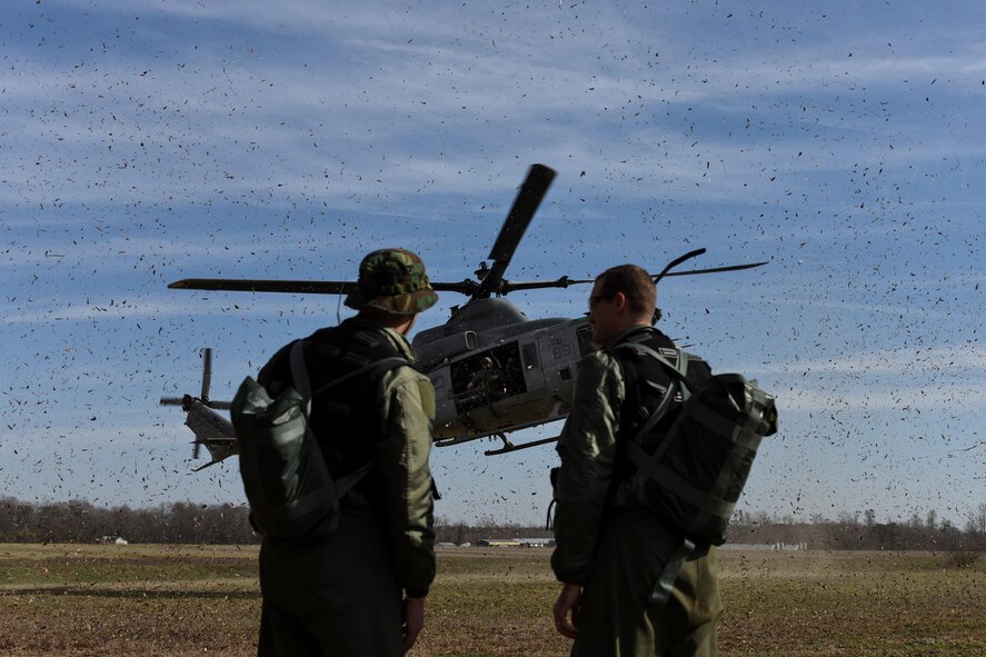 U.S. Air Force Capts. Cody Williams, 336th Fighter Squadron weapons systems officer, and Steve Keck, 336th FS pilot, are located by a rescue team in an AH-1W Super Cobra assigned to the Marine Light Aircraft Helicopter Squadron 269 from Marine Corps Air Station New River, in Jacksonville, North Carolina, during a tactical recovery of aircraft and personnel exercise, Jan. 31, 2017, in Kinston, North Carolina. Williams and Keck successfully evaded simulated enemy forces and coordinated rescue during the scenario. (U.S. Air Force photo by Airman Miranda A. Loera)