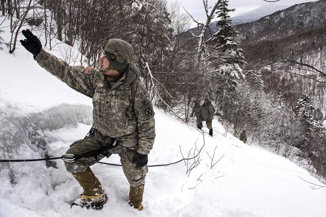 Army National Guard Spc. Breckenridge leads his team in a mountain hike at Smugglers' Notch in Jeffersonville, Vt., Jan. 28, 2017. Breckenridge is assigned to the Vermont Army National Guard’s Company A, 3rd Battalion, 172nd Infantry Regiment, 86th Infantry Brigade Combat Team (Mountain). As part of their annual winter training, soldiers enhanced their mountaineering skills in skiing, ice climbing and rappelling. Air National Guard photo by Tech. Sgt. Sarah Mattison