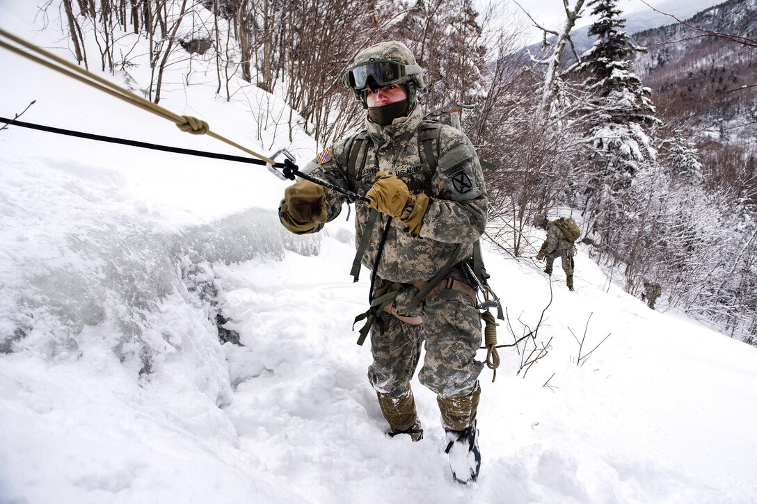 Army National Guard soldiers use safety ropes while participating in a mountain hike at Smugglers' Notch in Jeffersonville, Vt., Jan. 28, 2017. Air National Guard photo by Tech. Sgt. Sarah Mattison