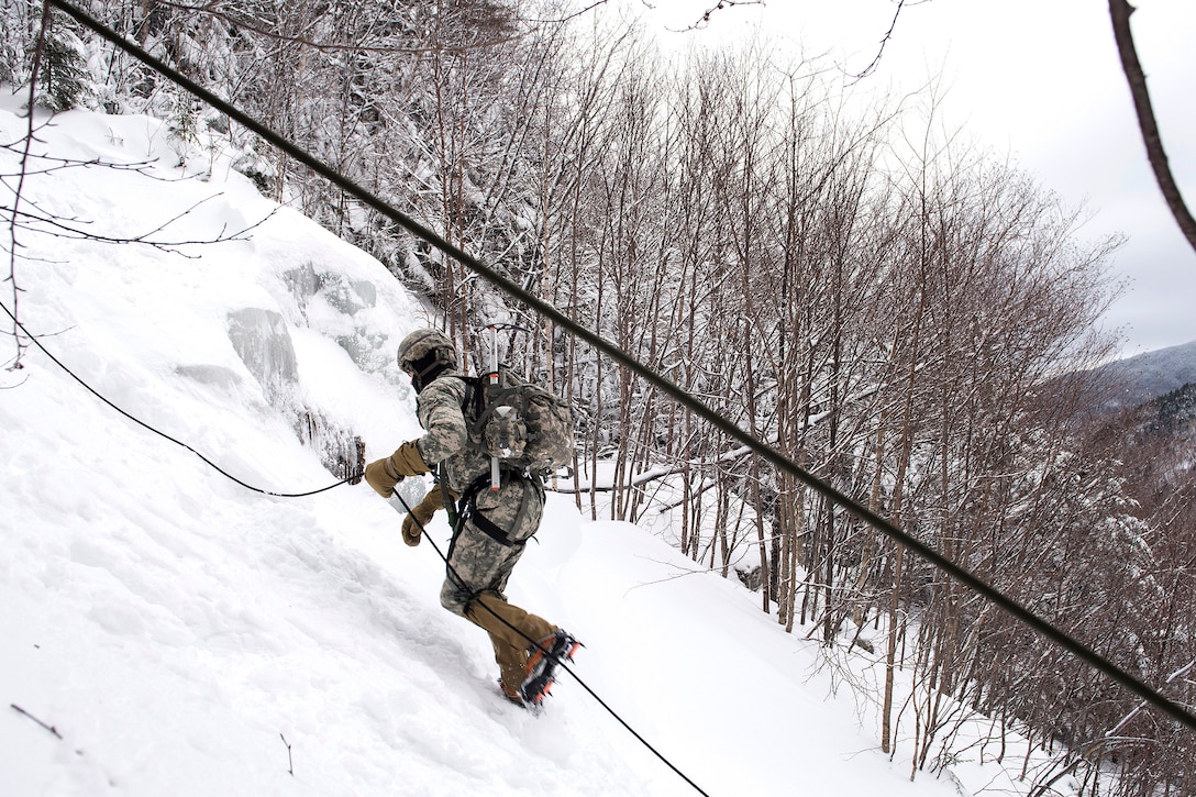 An Army National Guard soldier climbs a mountain at Smugglers' Notch in Jeffersonville, Vt., Jan. 28, 2017. Air National Guard photo by Tech. Sgt. Sarah Mattison