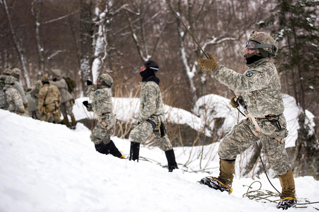 Army National Guard soldiers use a belaying rope during an ice-climbing exercise at Smugglers' Notch in Jeffersonville, Vt., Jan. 28, 2017. Air National Guard photo by Tech. Sgt. Sarah Mattison