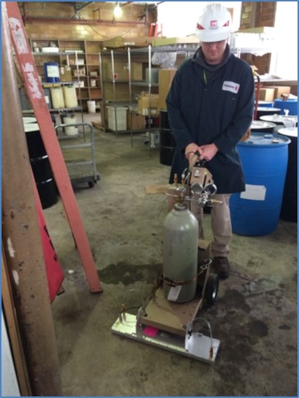 Buffalo District Health Physicists using radiation detectors to scan floors in a potentially contaminated building, similar surveys will be conducted at the NIST. 