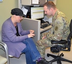 Shawna Jones, oncology patient, shows Army Capt. (Dr.) Joshua Fenderson, her primary oncologist, her fingernails during her appointment at Brooke Army Medical Center at Joint Base San Antonio-Fort Sam Houston Dec. 21, 2016.