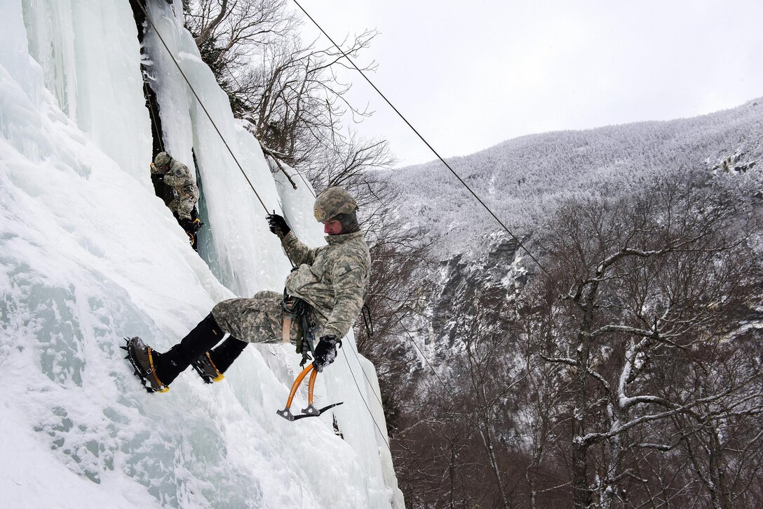 Army National Guard Sgt. 1st Class Christopher Zigler descends down an ice-covered cliff at Smugglers' Notch in Jeffersonville, Vt., Jan. 28, 2017. Zigler is assigned to the Vermont Army National Guard’s Company A, 3rd Battalion, 172nd Infantry Regiment, 86th Infantry Brigade Combat Team (Mountain). Air National Guard photo by Tech. Sgt. Sarah Mattison