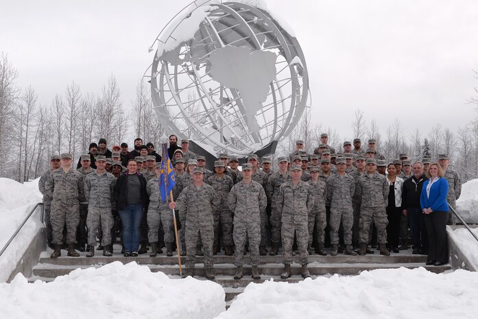 U.S. Air Force Airmen and civilians assigned to the 354th Communications Squadron (CS) pose for a group photo in the snow Jan. 26, 2017, at Eielson Air Force Base, Alaska. The 354th CS won the Air Force Lieutenant General Harold W. Grant Award for small communications unit. 