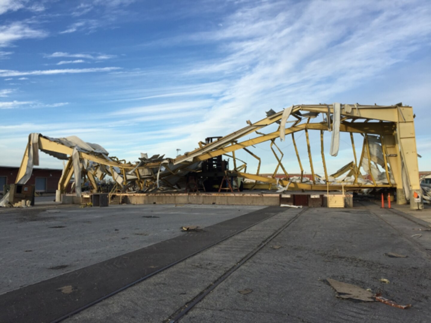 A DLA Distribution Albany, Georgia forklift is buried under the wreckage of a rail head ramp. The entire base received major damage from the category five hurricane that touched down on Jan. 22.  