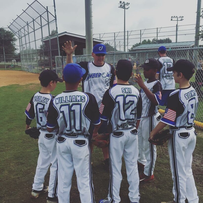 U.S. Air Force Staff Sgt. Patrick Bell, 33rd Operation Support Squadron aircrew flight equipment technician, speaks with players on a baseball team he coached, April 2016. Bell used his love of baseball to find balance between his life during and after duty hours. Because of his love of the sport of baseball, he has accepted a new coaching position for a Destin travel baseball team. (Courtesy Photo)