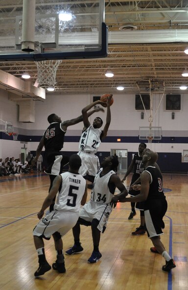 No. 22 Omarion Collins, a Hawks power forward, stretches as he shoots Saturday in the second game against the Fort Sill team in the Central U.S. Military Basketball League. The Hawks close by are No. 5 Ryan Rutledge, a shooting guard, and No. 34 Steven Dudley, point guard. The Hawks split the doubleheader at the Gerrity Fitness Center, winning the second game by 30 points. (Air Force photo by John Parker)