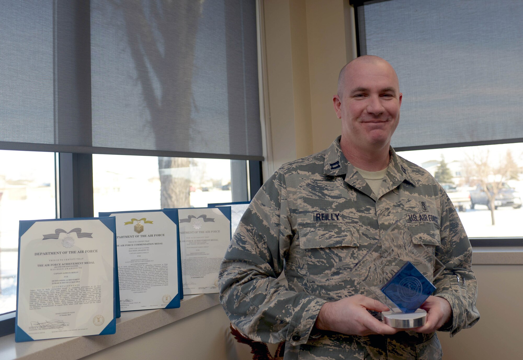 Capt. James Reilly, the bioenvironmental engineering flight commander assigned to the 28th Medical Group, holds the Military Health Leadership Excellence award for junior non-providers at Ellsworth Air Force Base, S.D., Jan. 26, 2017. The MHLE award is an annual award given to those who display great innovation in the medical field and is presented to the top junior providers and non-providers from each branch of the Department of Defense. (U.S. Air Force photo by Airman 1st Class Donald C. Knechtel)