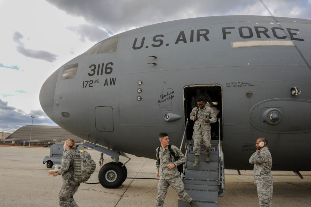 Members of the Mississippi Army National Guard, deplane a C-17 Globemaster III, at the Joint Base Andrews, Md., runway Jan. 18, 2017. The JRSOI welcomes and in-processes Airman and Soldiers who will support local authorities during the 58th Presidential Inauguration. More than 7,500 Guardsmen from 44 states, 3 territories (Guam, Puerto Rico & the U.S. Virgin Islands) and D.C. are providing critical functions for inaugural events. (U.S. Air National Guard photo by Senior Airman Anthony Small, JTF-DC) 