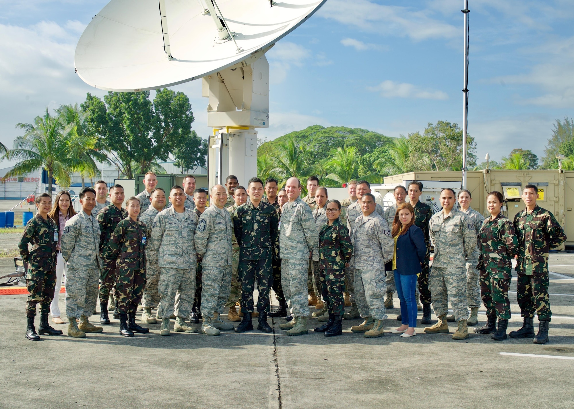 A group of U.S. and Philippine Air Force service members pose for a group photo after concluding a two-week Subject Matter Expert Exchange, Clark Air Base, Philippines, Jan. 25, 2017. Throughout the SMEE military members from both nations trained together using satellite imagery provided by Eagle Vision to enhance their combined readiness when conducting Humanitarian Assistance and Disaster Relief operations common in the Asia-Pacific. (U.S. Air Force photo by Tech. Sgt. James Stewart/Released)