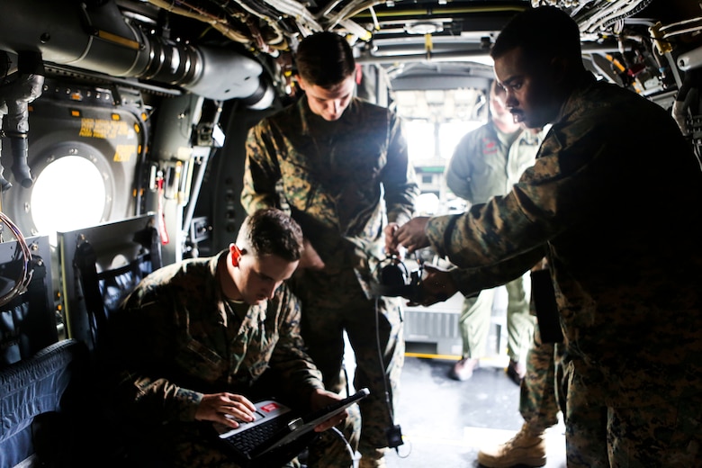 Marines with 3rd Marine Aircraft Wing prepares the Hatch Mounted SATCOM (Satellite Communication) Antenna System (HMSAS) to demonstrate to the 3rd MAW commanding general aboard Marine Corps Air Station Miramar, Calif., Jan. 9. The HMSAS was developed for pre-deployment training in order to enhance communications for raid force and tactical recovery of aircraft and personnel (TRAP) missions to support a Special Purpose Marine Air-Ground Task Force (SP-MAGTF). (U.S. Marine Corps photo by Cpl. Harley Robinson/Released)