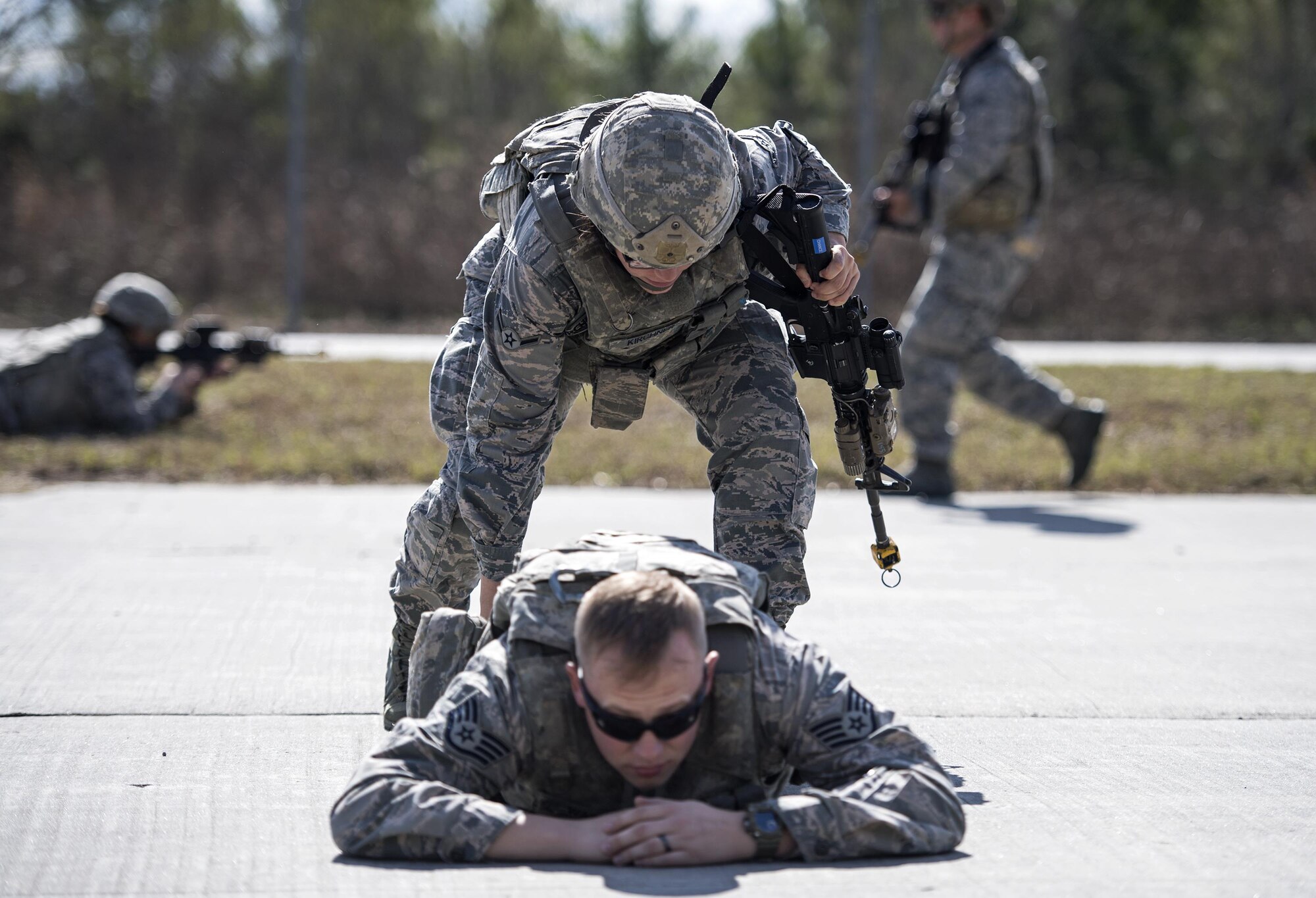 Airman Erin Kirchner, 822d Base Defense Squadron fire team member, checks a simulated casualty for weapons, Feb. 1, 2017, at Moody Air Force Base, Ga. Once the team has neutralized all threats, they systematically sweep the area for weapons and hazardous materials. (U.S. Air Force photo by Airman 1st Class Janiqua P. Robinson)