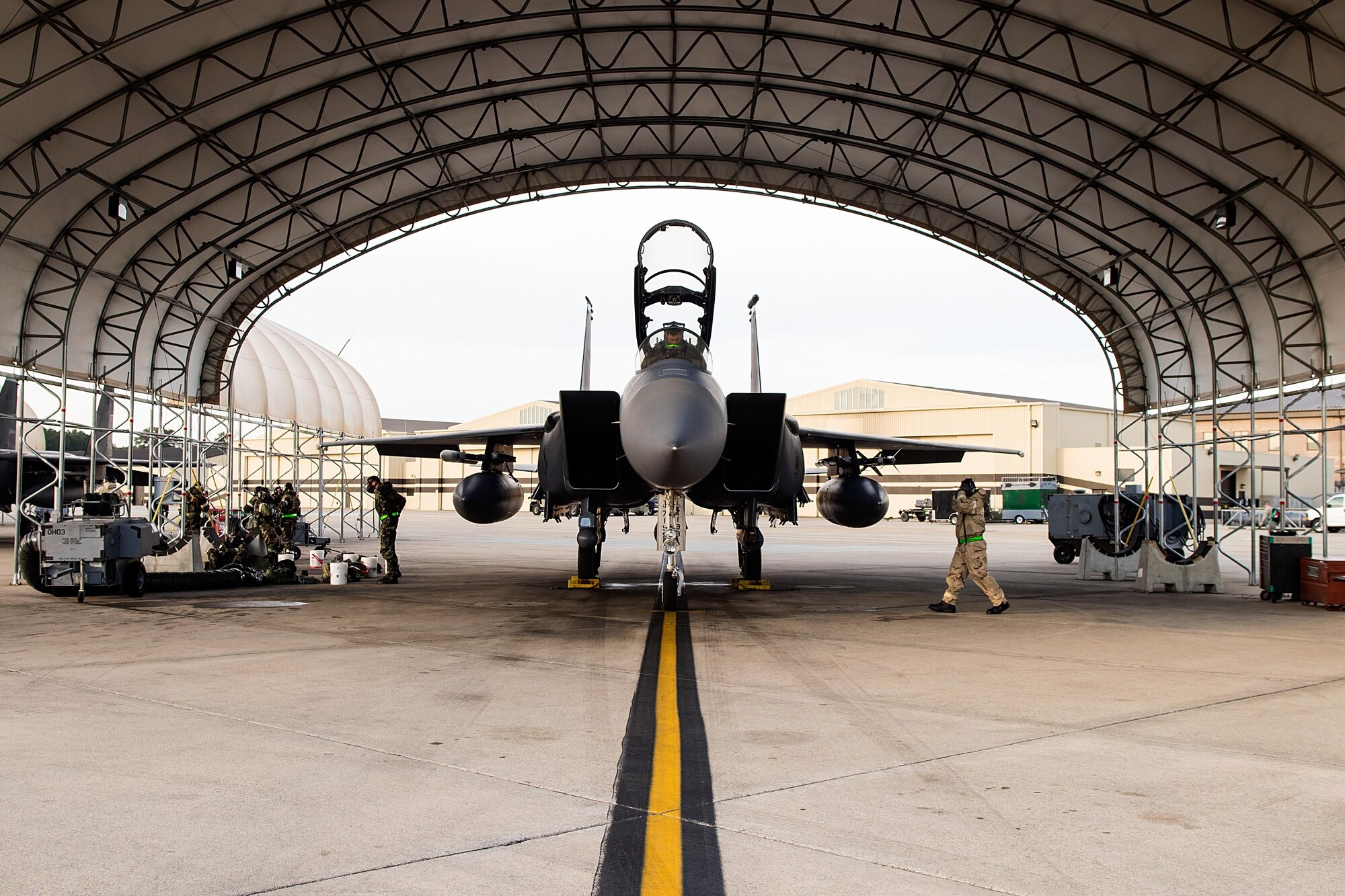 Airmen from the 4th Aircraft Maintenance Squadron prepare to launch an F-15E Strike Eagle assigned to the 335th Fighter Squadron during exercise Coronet Warrior 17-01, Jan. 31, 2017, at Seymour Johnson Air Force Base, North Carolina. Airmen were evaluated on their ability to conduct operations while fending off simulated air and ground attacks with a potential threat of chemical or biological agents, causing changes to mission orientated protective posture gear. (U.S. Air Force photo by Airman Shawna L. Keyes)