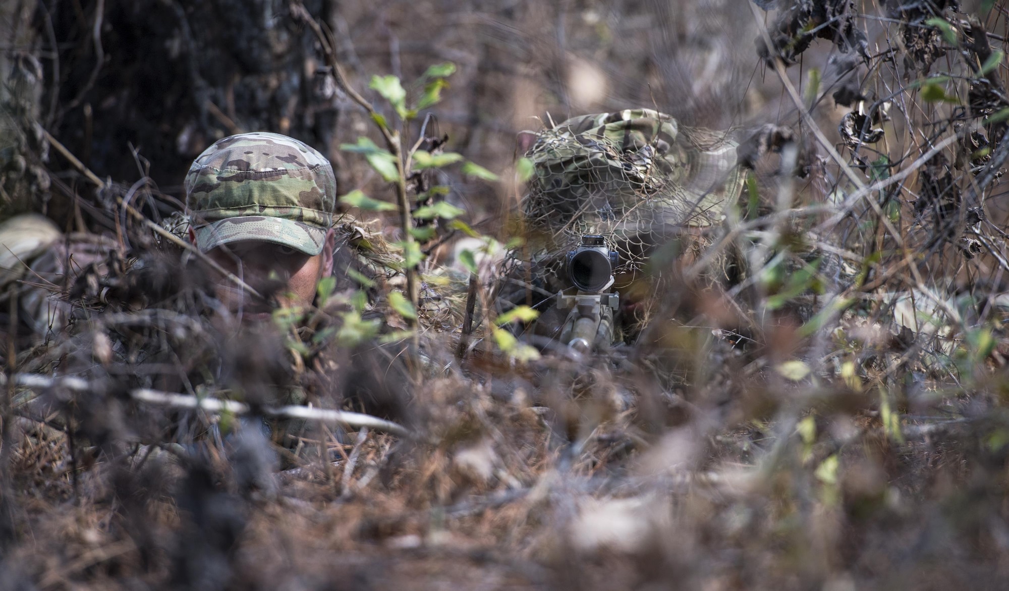 Airmen camouflage themselves during sniper training, Feb. 1, 2017, at Moody Air Force Base, Ga. Airmen had to prove they could neutralize a target without giving away their position. Airmen had two hours to crawl to a secluded spot, identify a target on a clipboard and fire their weapon without giving away their position. (U.S. Air Force photo by Airman 1st Class Janiqua P. Robinson)