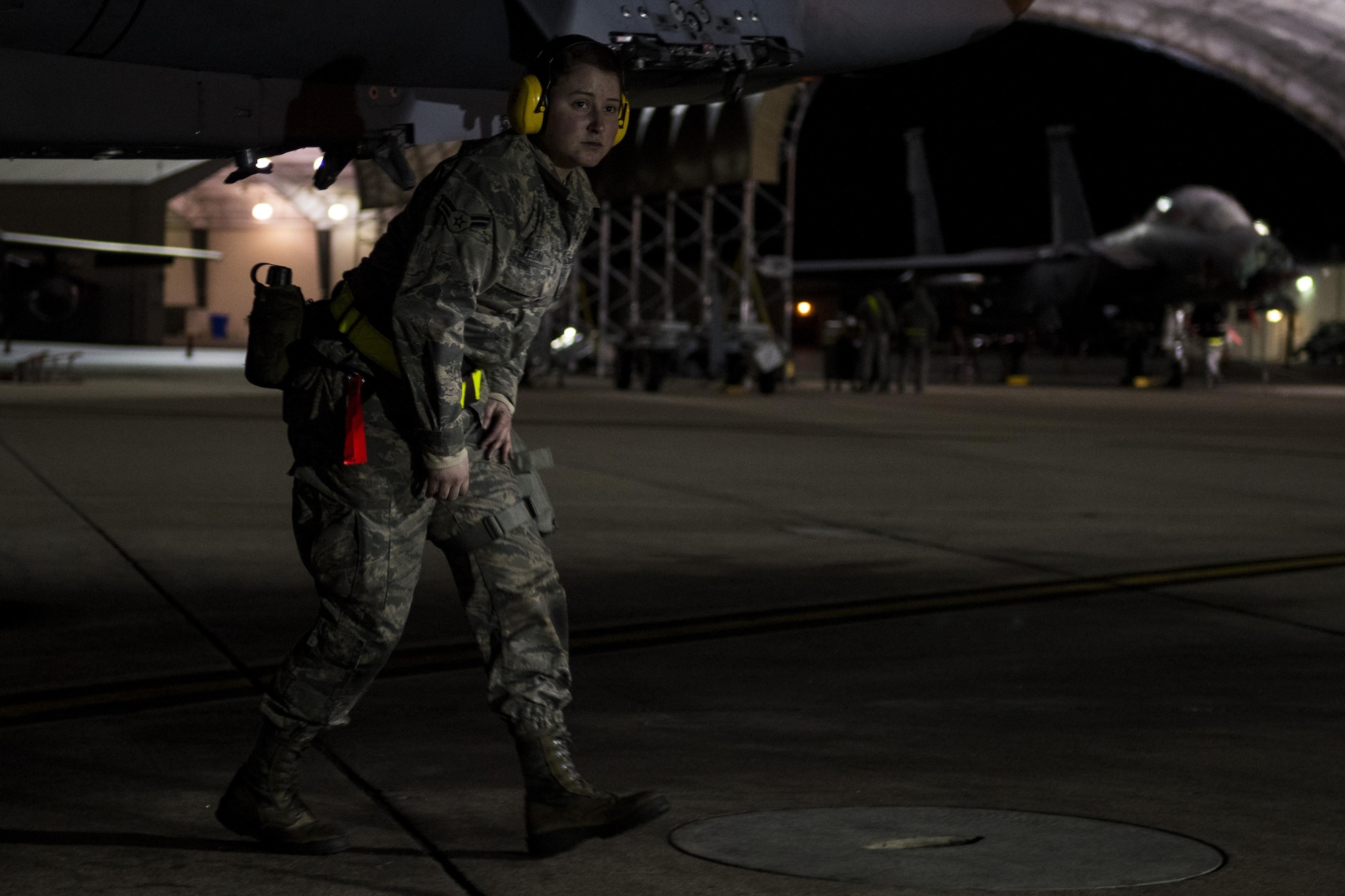 Airman 1st Class Melina Yeoman, 4th Aircraft Maintenance Squadron weapons load crew member, conducts a check on an F-15E Strike Eagle during exercise Coronet Warrior 17-01, Jan. 31, 2017, at Seymour Johnson Air Force Base, North Carolina. 24-hour operations were conducted during the exercise. (U.S. Air Force photo by Airman Shawna L. Keyes)