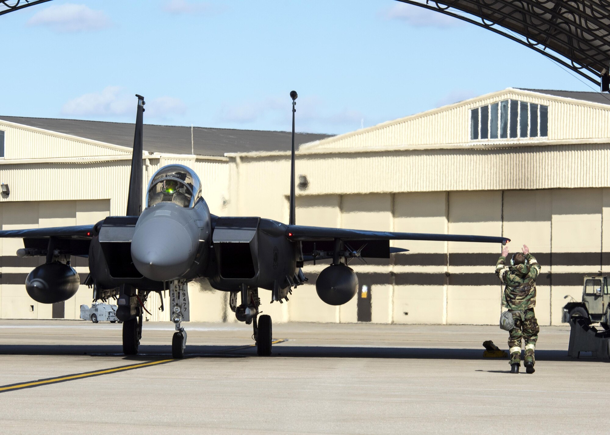 An Airman from the 4th Aircraft Maintenance Squadron marshals an F-15E Strike Eagle during exercise Coronet Warrior 17-01, Jan. 30, 2017, at Seymour Johnson Air Force Base, North Carolina. Airmen from the 4th AMXS conducted routine launches while in various levels of Mission Oriented Protective Posture gear. (U.S. Air Force photo by Airman Shawna L. Keyes)