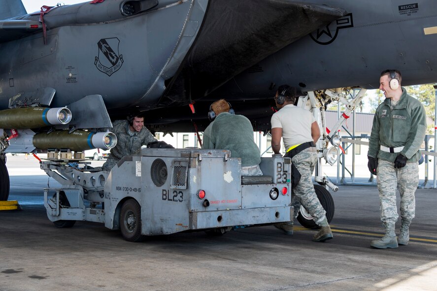 Airmen from the 4th Aircraft Maintenance Squadron weapons shop load munitions during exercise Coronet Warrior 17-01, Jan. 30, 2017, at Seymour Johnson Air Force Base, North Carolina. Airmen were evaluated on their speed and accuracy while fully loading an F-15E Strike Eagle to simulate combat aircraft configurations. (U.S. Air Force photo by Airman Shawna L. Keyes)