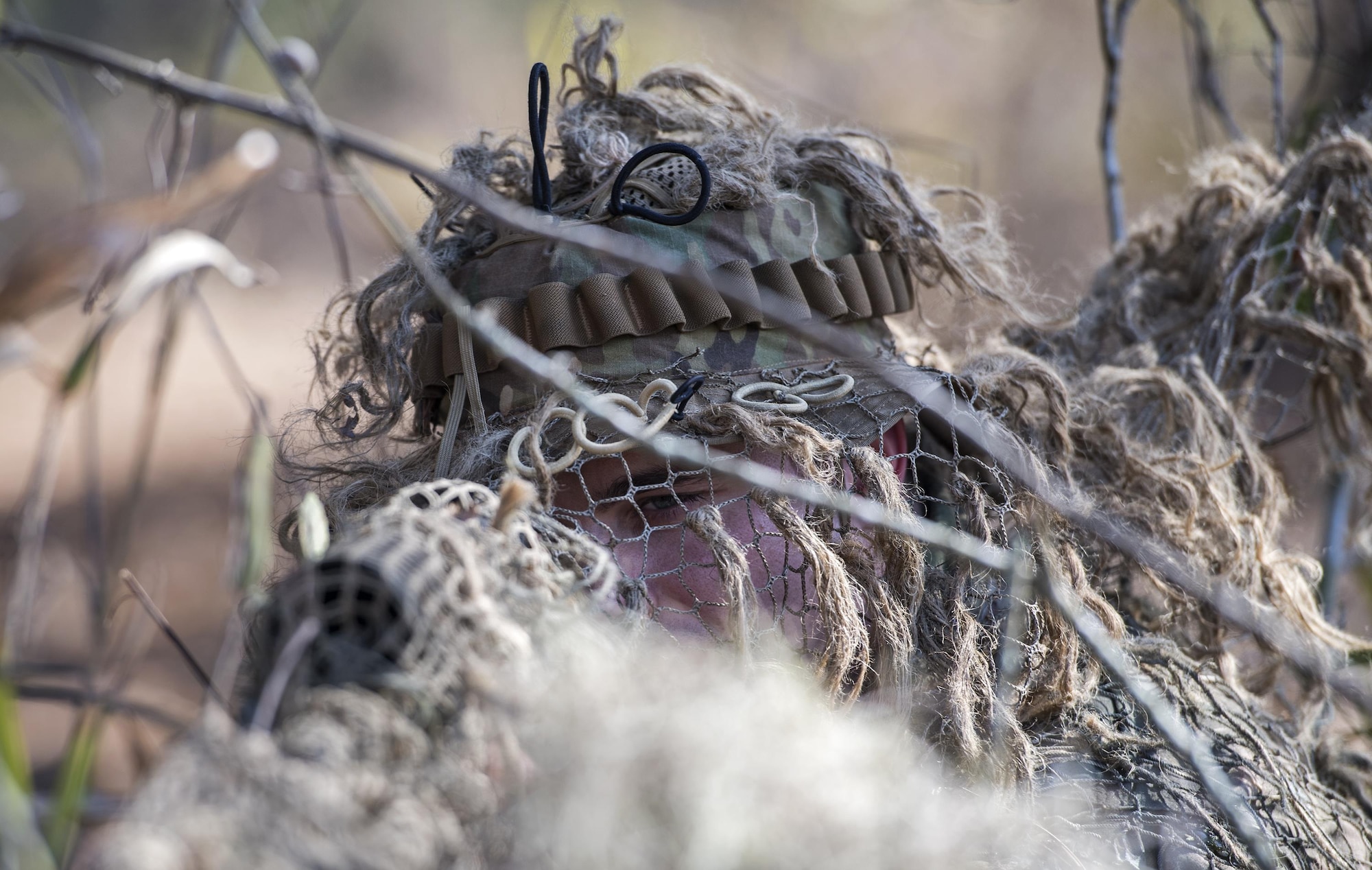 Staff Sgt. Joshua Bauer, 822d Base Defense Squadron close precision engagement team member, aims at a target during sniper training, Feb. 1, 2017, at Moody Air Force Base, Ga. Airmen crawled 50 to 100 meters to find spots where they could see the training leaders using scopes and binoculars, without the training leader seeing them. (U.S. Air Force photo by Airman 1st Class Janiqua P. Robinson)