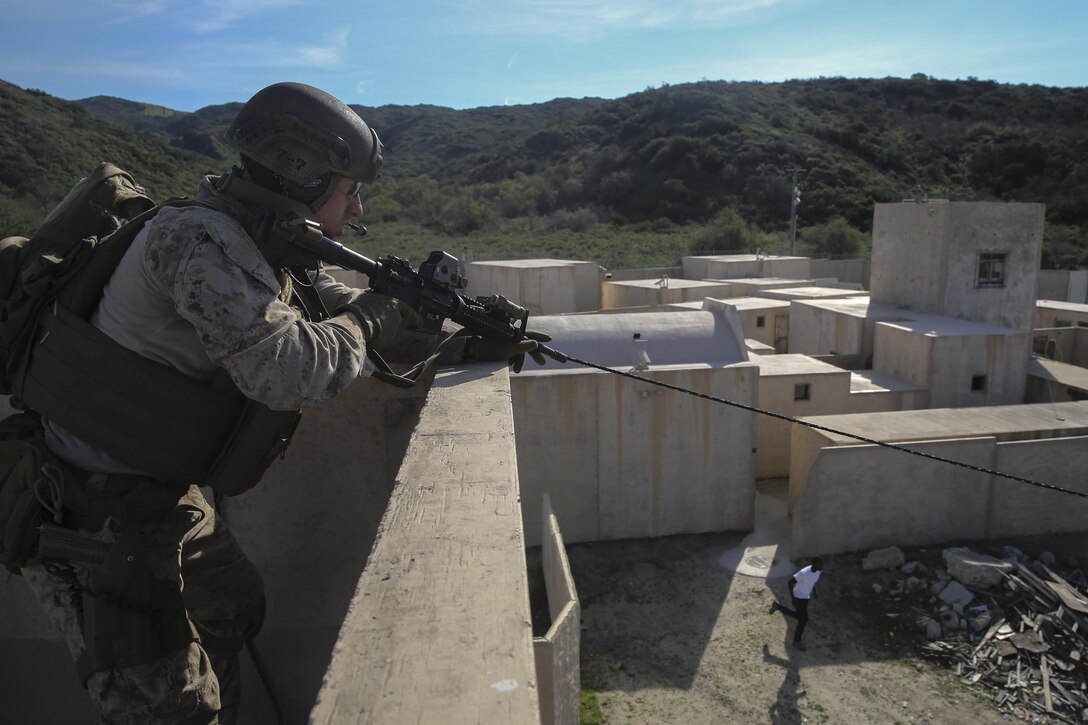 MARINE CORPS BASE CAMP PENDLETON, Calif.— A Marine with the 15th Marine Expeditionary Unit Maritime Raid Force provides security with eyes on a roll player from a roof top during an Interoperability Exercise at Camp Pendleton, Jan. 30, 2017. This exercise affords the opportunity for Marines from supporting units to begin training side by side with the MRF in preparation for deployment this year. The pre-deployment training the 15th MEU is conducting ensures the MEU  is prepared to answer the Nation’s call should the need arise. (U.S. Marine Corps photo by Cpl. Timothy Valero)