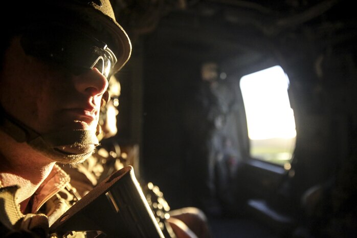 MARINE CORPS BASE CAMP PENDLETON, Calif. – A Marine with the 15th Marine Expeditionary Unit Maritime Raid Force looks around the MV-22 Osprey after taking off during an Interoperability Exercise on Camp Pendleton, Jan. 30, 2017. This exercise builds the relationship between the Marines from the supporting units and the MRF since they will be working closely during operations while deployed. The 15th MEU’s forces undergo demanding unit-level training in order to be proficient in every critical mission area needed to respond to any mission while deployed. (U.S. Marine Corps photo by Cpl. Timothy Valero)