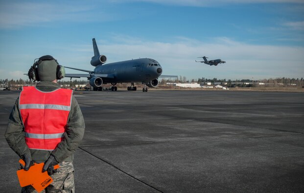 Senior Airman William Roten, 821st Contingency Response Squadron maintainer, prepares to marshal a KC-10 Extender aircraft from Travis Air Force Base, Calif., Jan. 23, 2017, at Joint Base Lewis-McChord, Washington. Airmen from the 821st Contingency Response Group, exercised their capability to support humanitarian efforts during exercise Dragon Breath at JBLM and Fairchild Air Force Base. (U.S. Air Force photo by Staff Sgt. Robert Hicks)