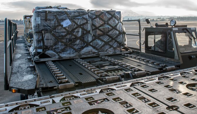 Staff Sgt. Jorge Hernandez, 821st Contingency Response Squadron, uses a K-loader to load cargo onto a KC-10 Extender aircraft from Travis Air Force Base, Calif., Jan. 23, 2017, at Joint Base Lewis-McChord, Washington. Airmen from the 821st Contingency Response Group, exercised their capability to support humanitarian efforts during exercise Dragon Breath at JBLM and Fairchild Air Force Base. (U.S. Air Force photo by Staff Sgt. Robert Hicks)