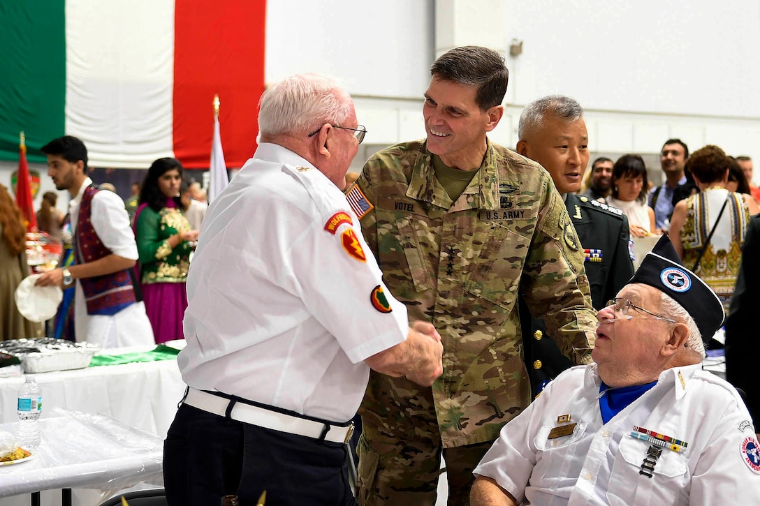 Army Gen. Joseph L. Votel, commander of U.S. Central Command, greets attendees at Coalition International Night at MacDill Air Force Base, Fla., Dec. 1, 2016. Air Force photo by Tech. Sgt. Dana Flamer