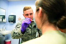 Senior Airman Nathaniel Morris, 341st Medical Operation Squadron personnel reliability assurance program clinic technician, performs preliminary vital checks on a patient Jan. 30, 2017, at Malmstrom Air Force Base, Mont. Morris works in the PRAP clinic which ensures all Airmen required to comply with the program are taken care of medically. (U.S. Air Force photo/Airman 1st Class Magen M. Reeves)