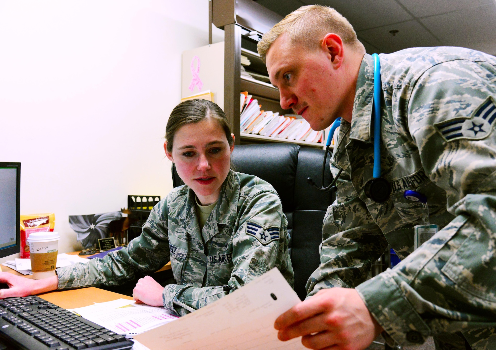 Senior Airmen Jeslyn Raetz, left, and Nathaniel Morris, right, both 341st Medical Operation Squadron technicians, check quality assurance on patients’ medical paperwork Jan. 30, 2017, at Malmstrom Air Force Base, Mont. Medical files for all patients seen each day must be filled out properly because they are an inspectable item. (U.S. Air Force photo/Airman 1st Class Magen M. Reeves)