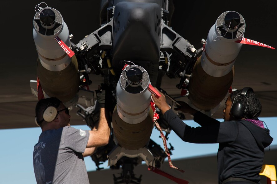 Airmen load three 500 pound bombs are loaded under the wing of a B-52 Stratofortress at Barksdale Air Force Base, La, Feb. 1, 2017. Earlier, the Airmen installed munitions on a Conventional Rotary Launcher, a new weapons system allowing the B-52 to carry up to eight different types of bombs on a single mission. The CRL was being tested for the first time in a live fire training mission (U.S. Air Force photo by Staff Sgt. Jason McCasland/Released)