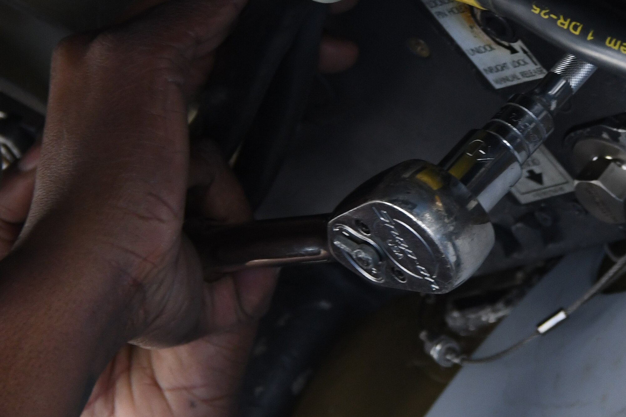 A ratchet is inserted into a bomb latching mechanism on a conventional rotary launcher, at Barksdale Air Force Base, La., Feb. 1. 2017. The ratchet locks down the loaded munitions onto the CRL, which can rotate through either eight joint direct attack munitions, and extended-range joint air-to-surface standoff missiles and even miniature air-launched decoys.  The CRL was being prepped to undergo its first live-fire training mission. (U.S. Air Force photo by Tech. Sgt. Ted Daigle/released)