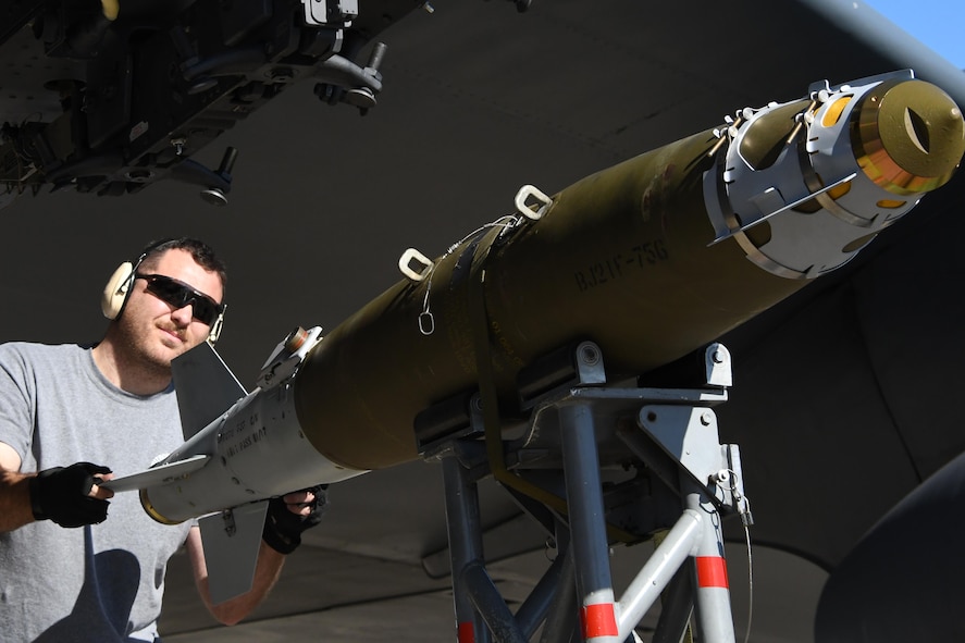 Tech. Sgt. Matt Gerrits, 307th Aircraft Maintenance Squadron armament systems specialist, loads a 500 pound Joint Direct Attack Munitions under the wing of a B-52 Stratofortress at Barksdale Air Force Base, La., Feb. 1, 2017. The JDAM is a guidance tail kit that converts existing unguided free-fall bombs into accurate, adverse weather "smart" munitions. This enables employment of accurate air-to-surface weapons against high priority fixed and relocatable targets from fighter and bomber aircraft. Gerrits was loading the weapons in conjunction other loaded on the Conventional Rotary Launcher, a new weapons system capable of carrying several different types of munitions at one time.  The CRL was being prepped to undergo its first live-fire training mission. (U.S. Air Force photo by Tech. Sgt. Ted Daigle/released)
