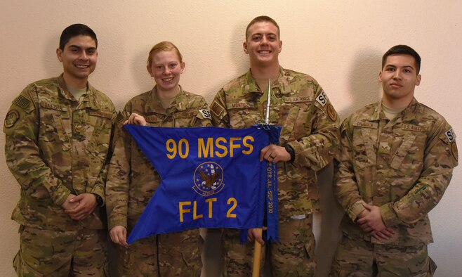 Airmen with the 90th Missile Security Forces Squadron pose for a group photo at F.E. Warren Air Force Base, Wyo., Jan. 27, 2017. The defenders were recognized for rendering aid to civilians at the site of a car accident in December 2016. (U.S. Air Force photo by Airman 1st Class Breanna Carter)