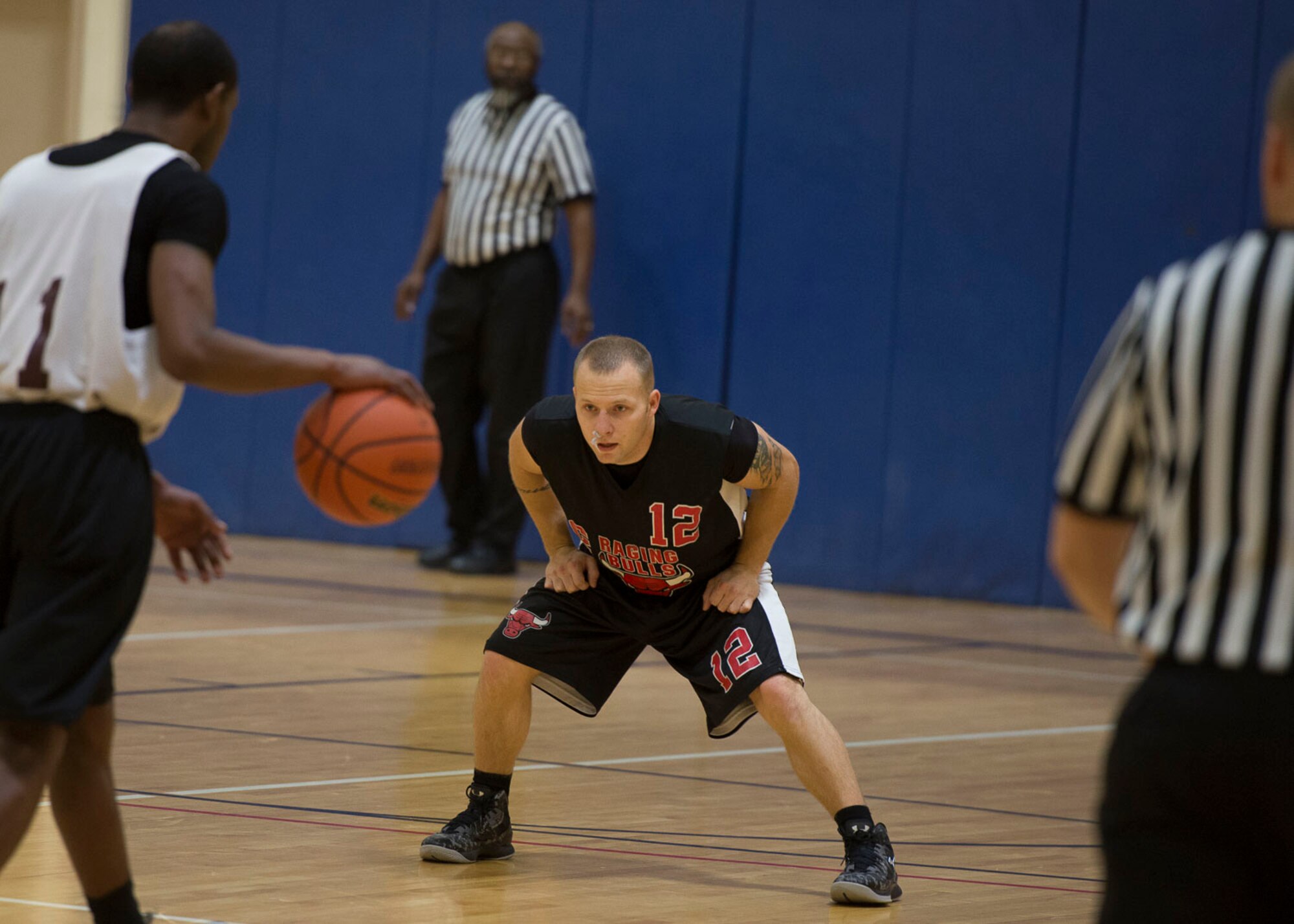 Kyle Durbin, Civil Engineer Squadron point guard, prepares to defend Maintenance Group point guard, Brandon Taylor, during the Intramural Basketball Championship game, Jan. 30, at Mountain Home Air Force Base, Idaho. Durbin battled a bloody nose throughout the game starting at the 1:29 mark in the first half.