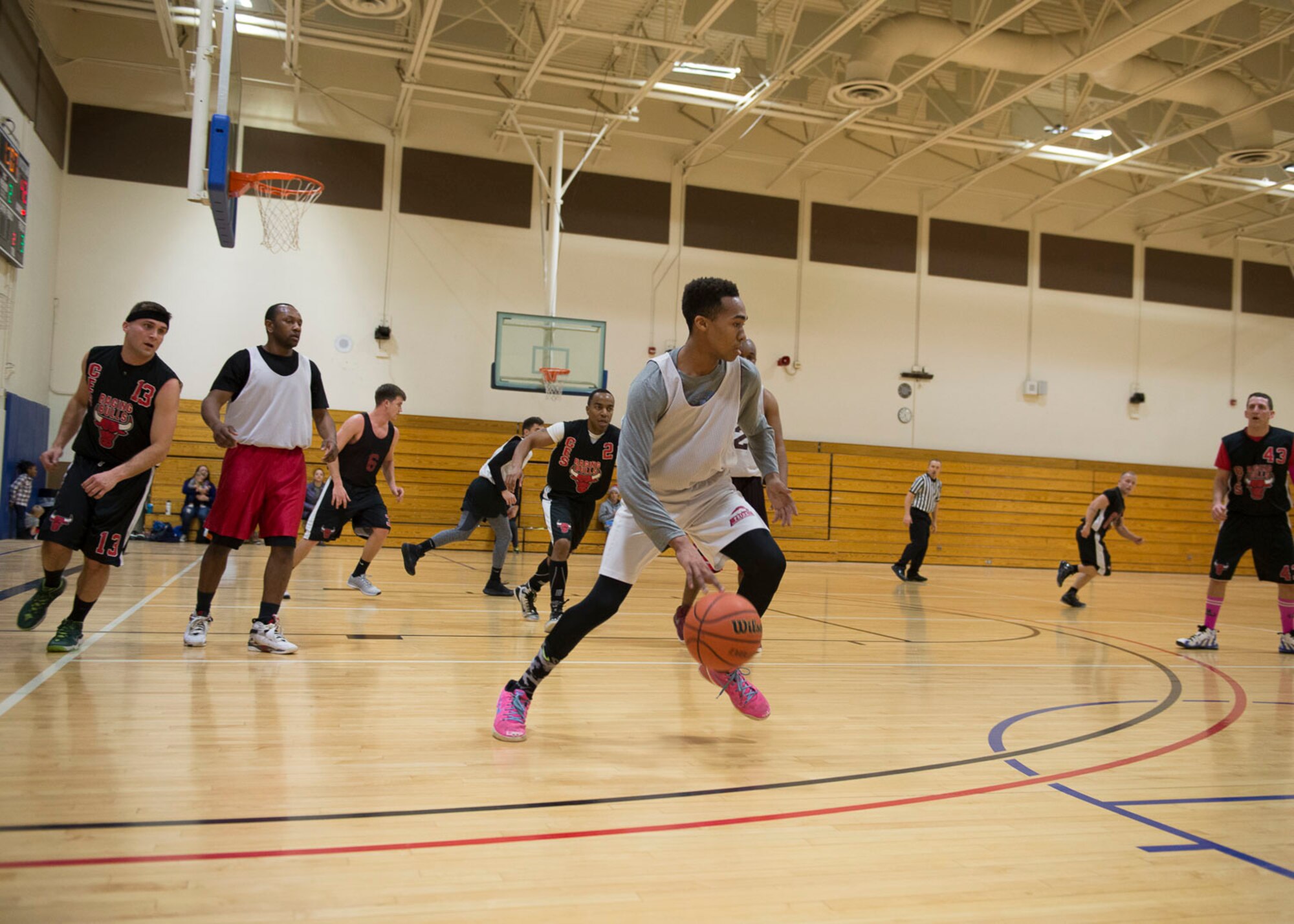 Bryce Jordan, Maintenance Group guard, pushes the ball up the court during the Intramural Basketball Championship game, Jan. 30, at Mountain Home Air Force Base, Idaho. Jordan scored five points in MXG's 51-42 victory over Civil Engineer Squadron.