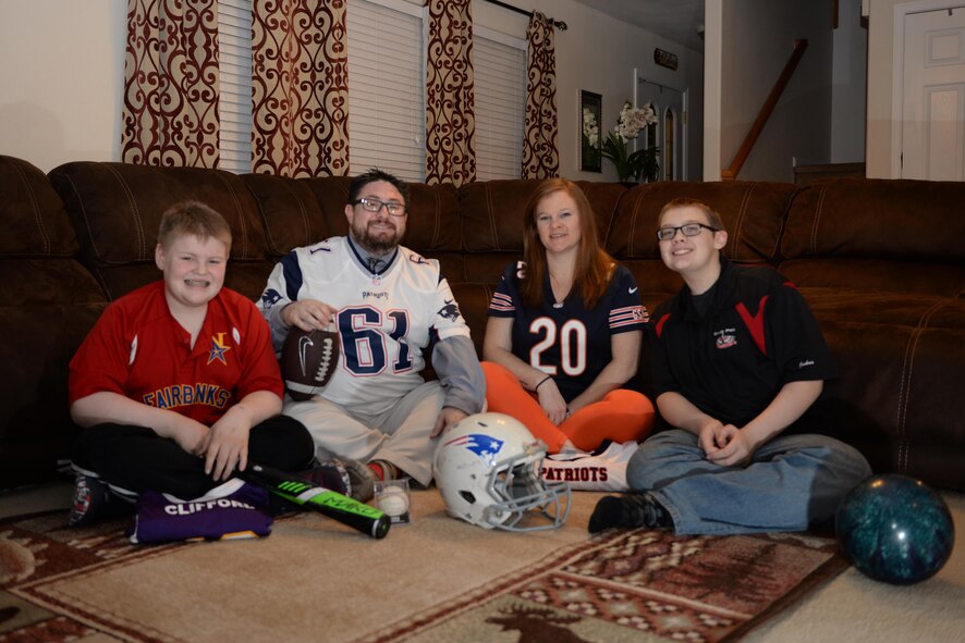 The Clifford family poses for a photo in their cozy family room, surrounded by the sports they enjoy, Jan. 31, 2017, in North Pole, Alaska. The Clifford’s love spending time together and enjoying watching and participating in sports. (U.S. Air Force photo by Airman 1st Class Cassandra Whitman)