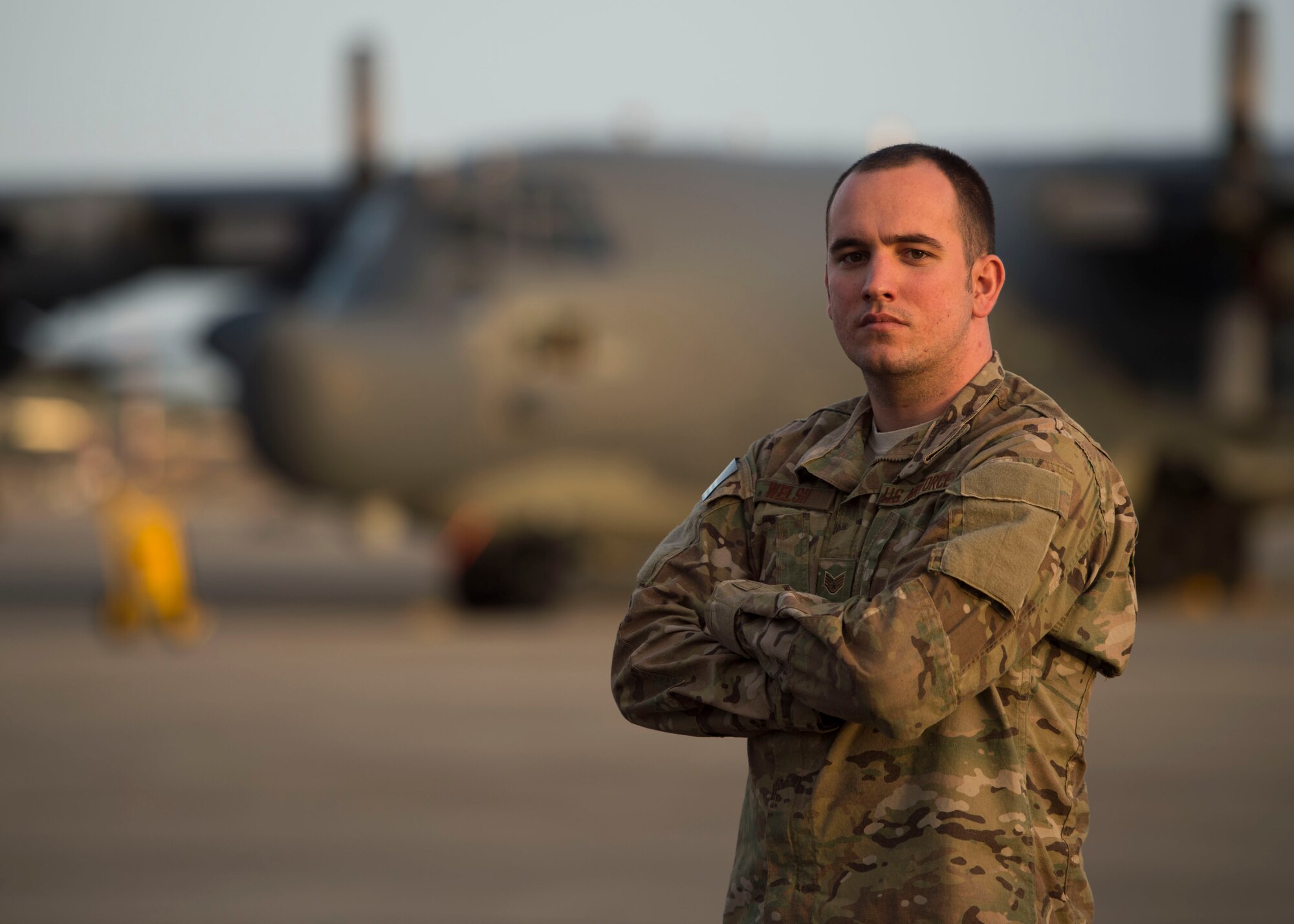 Staff Sgt. Stephen Welsh, a communication navigation systems craftsman with the 901st Special Operations Aircraft Maintenance Squadron, stands in front of an MC-130H Combat Talon II on the flightline at Hurlburt Field, Fla., Jan. 25, 2017. Welsh was selected to retrain into the remotely piloted aircraft sensor operator career field. (U.S. Air Force photo by Senior Airman Krystal M. Garrett) 