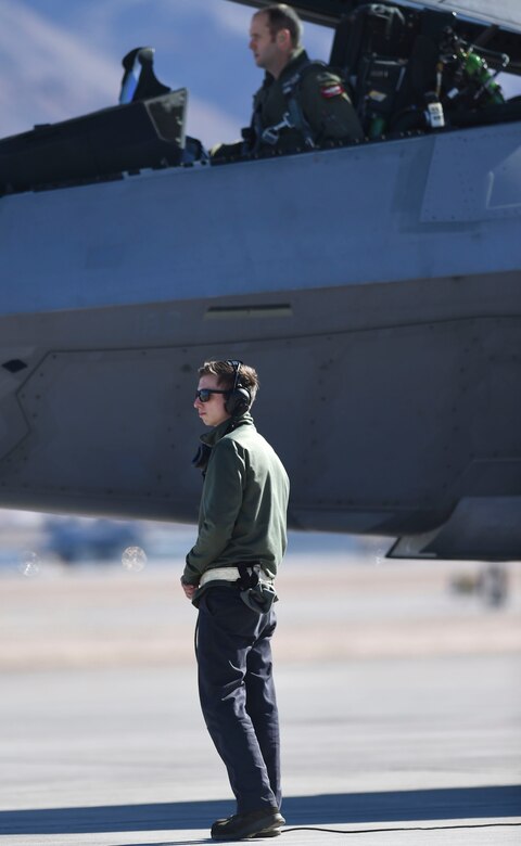 U.S. Air Force Airman 1st Class Brian Dowling, 27th Aircraft Maintenance Unit crew chief, watches as U.S. and coalition aircraft take-off during Red Flag 17-1 at Nellis Air Force Base, Nev., Jan. 26, 2017. Red Flag 17-1 features a large force training involving U.S. and coalition forces working together in a cyber, space and air battlefield domains. (U.S. Air Force photo by Staff Sgt. Natasha Stannard)