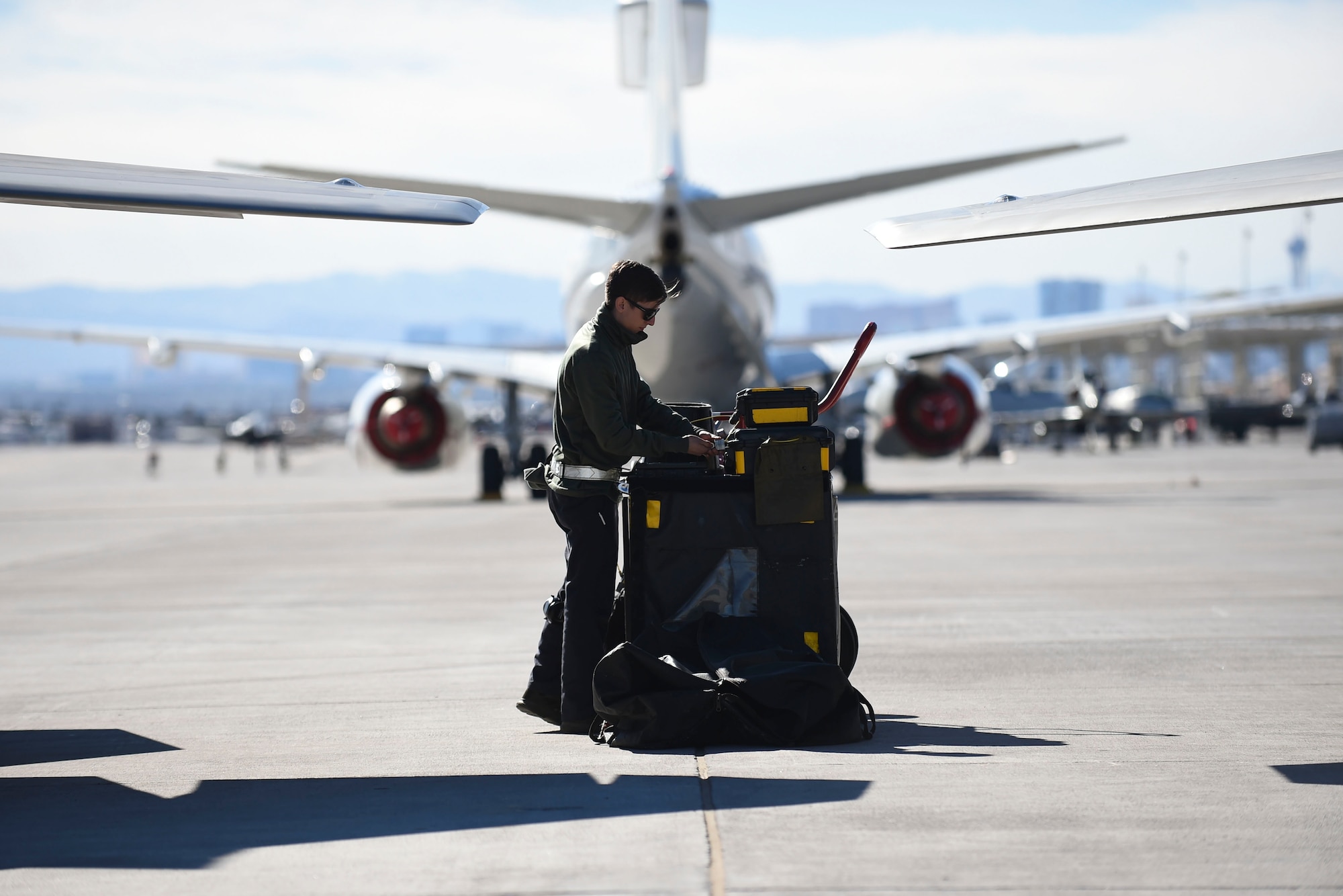 U.S. Air Force Airman 1st Class Brian Dowling, 27th Aircraft Maintenance Unit crew chief, checks his equipment before conducting preflight inspections on an F-22 Raptor during Red Flag 17-1 at Nellis Air Force Base, Nev., Jan. 26, 2017. Red Flag 17-1 includes not only Raptor aircrews and support, but fellow fifth generation F-35A Lightning II crews. (U.S. Air Force photo by Staff Sgt. Natasha Stannard)
