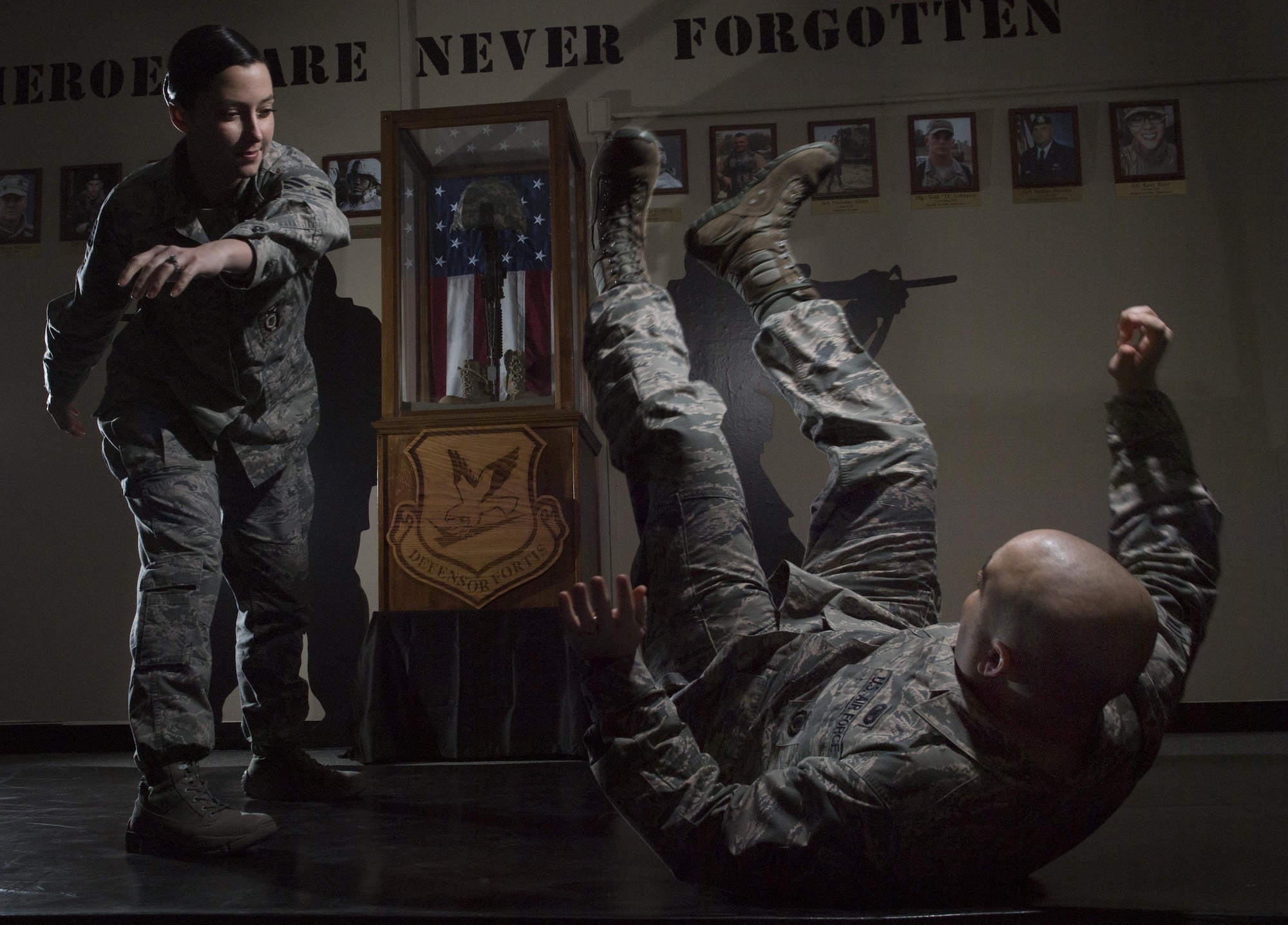 Staff Sgt. Kiirsten Gunterman, 374th Security Forces Squadron training instructor, performs a takedown on Senior Airman Ryan Vanicek, 374 SFS unit training manager at Yokota Air Base, Japan, Jan. 20, 2017. Gunterman spent 17 years practicing ballet before joining the Air Force. Her duties include instructing Combatives classes, where she teaches defenders to overcome larger, stronger oponents. (U.S. Air Force photo by Senior Airman Elizabeth Baker)