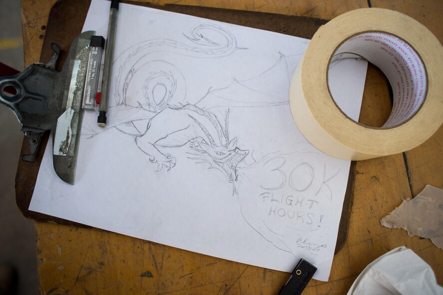 Staff Sgt. Anita, 380th Expeditionary Aircraft Maintenance Squadron U-2 maintainer, prepares to create a mural for a historical U-2 achievement at an undisclosed location in Southwest Asia, Jan. 28, 2017. Upon completion of the project several Airmen signed the artwork. The art work will be displayed at the 380 EAMXS for future Airmen. (U.S. Air Force photo/Senior Airman Tyler Woodward)