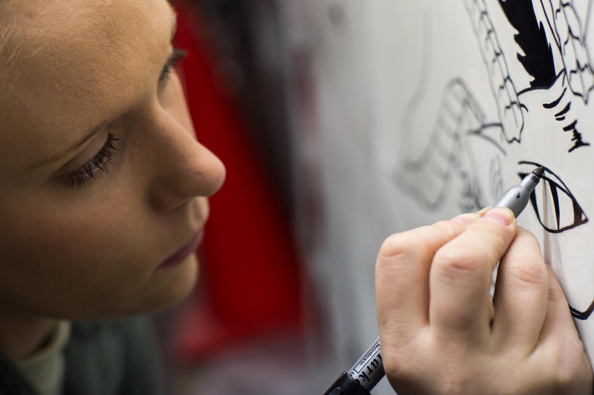 Staff Sgt. Anita, 380th Expeditionary Aircraft Maintenance Squadron U-2 maintainer, traces a mural for a historical U-2 achievement at an undisclosed location in Southwest Asia, Jan. 30, 2017.  (U.S. Air Force photo/Senior Airman Tyler Woodward)